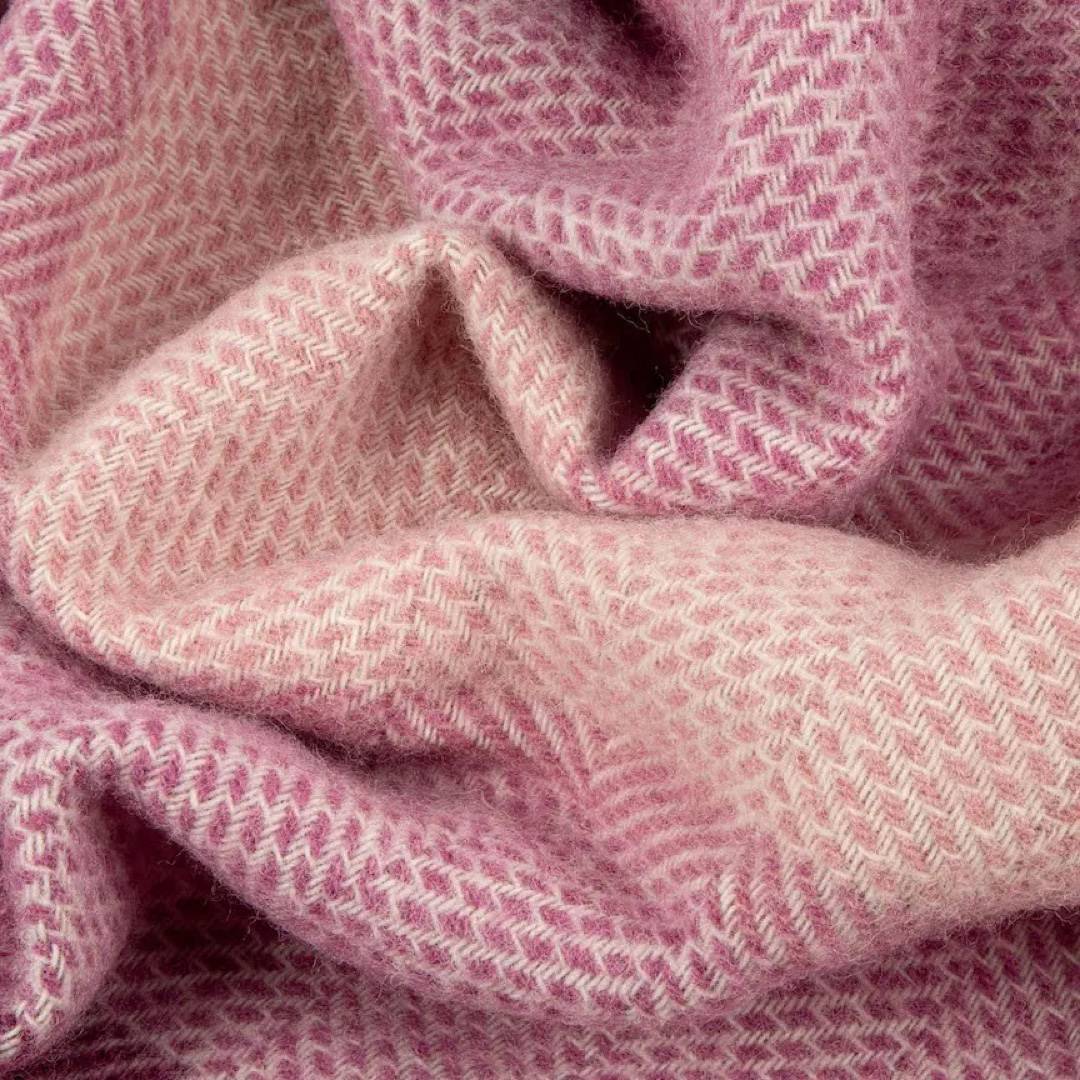This pink, striped, cosy and fluffy blanket is made from 100% pure new wool and finished with extra brushing to make it exceptionally soft.