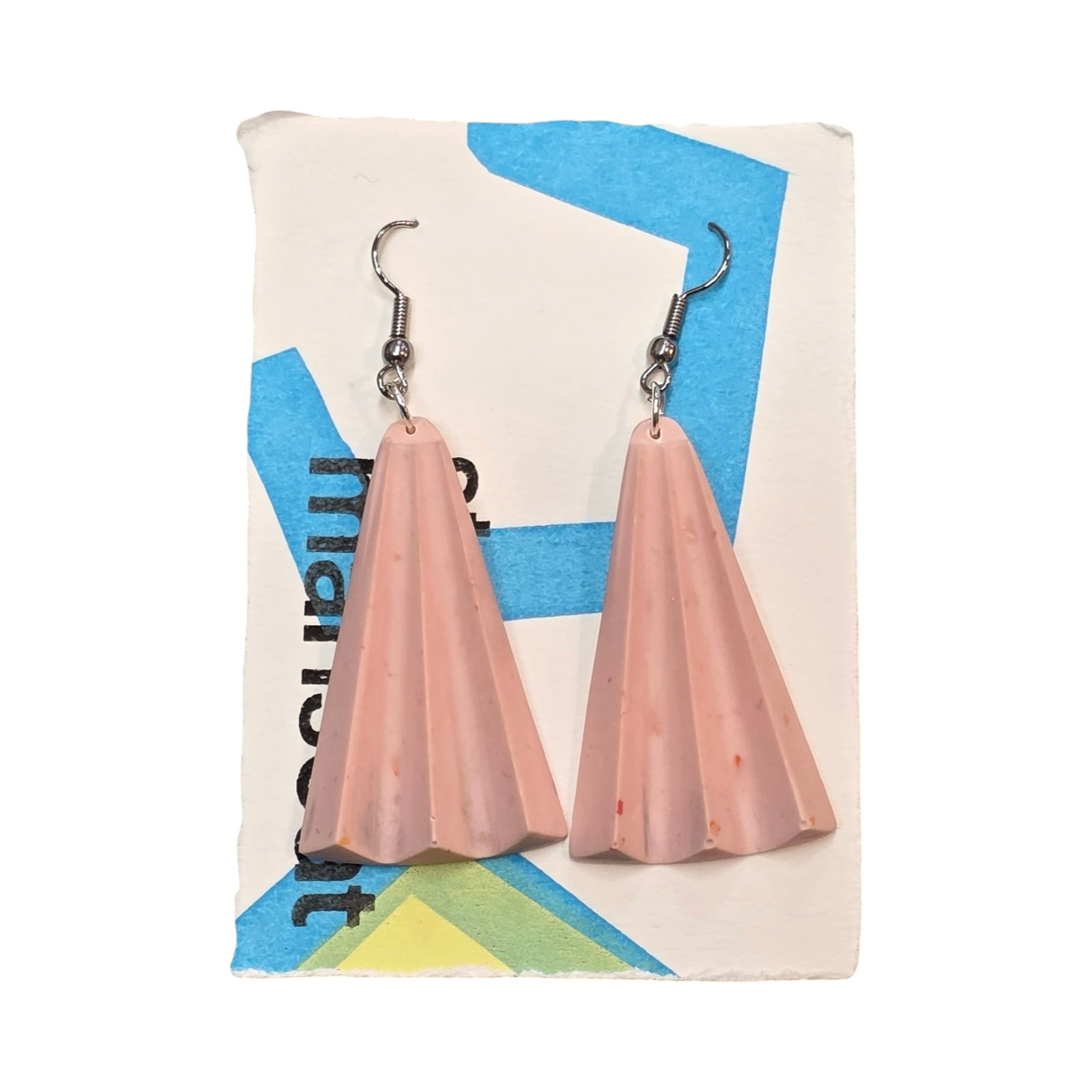Pink earrings are shaped like rays of sunshine.