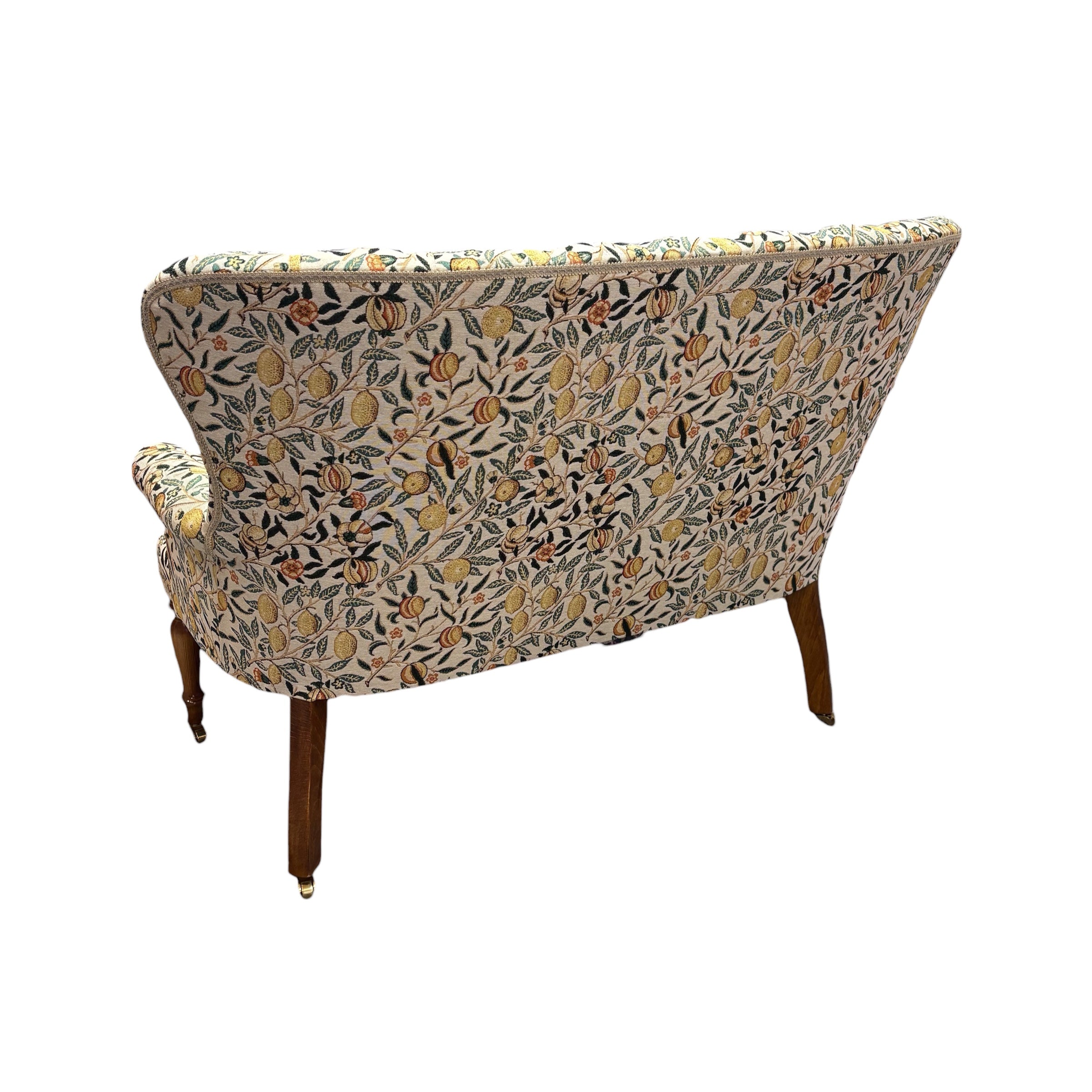 A beautiful hand-crafted occasional two-seater sofa with a high button back covered in gorgeous fabulous woven William Morris style pomegranate fruits fabric in cream with yellow fruit.