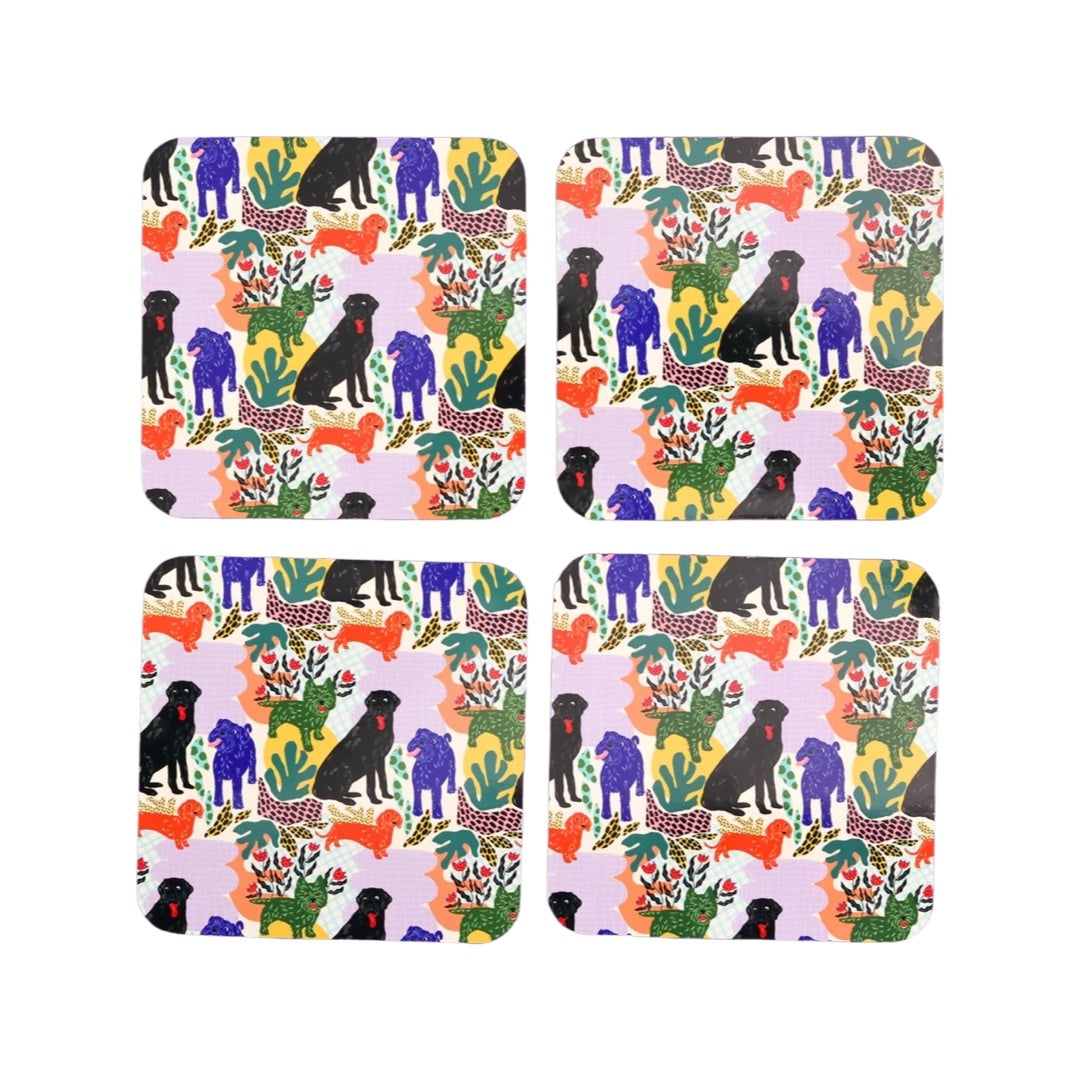 Set of 4 adorable dog coasters, featuring black labradors, orange dachshunds and green scottie dogs with green leaves and a lilac background.