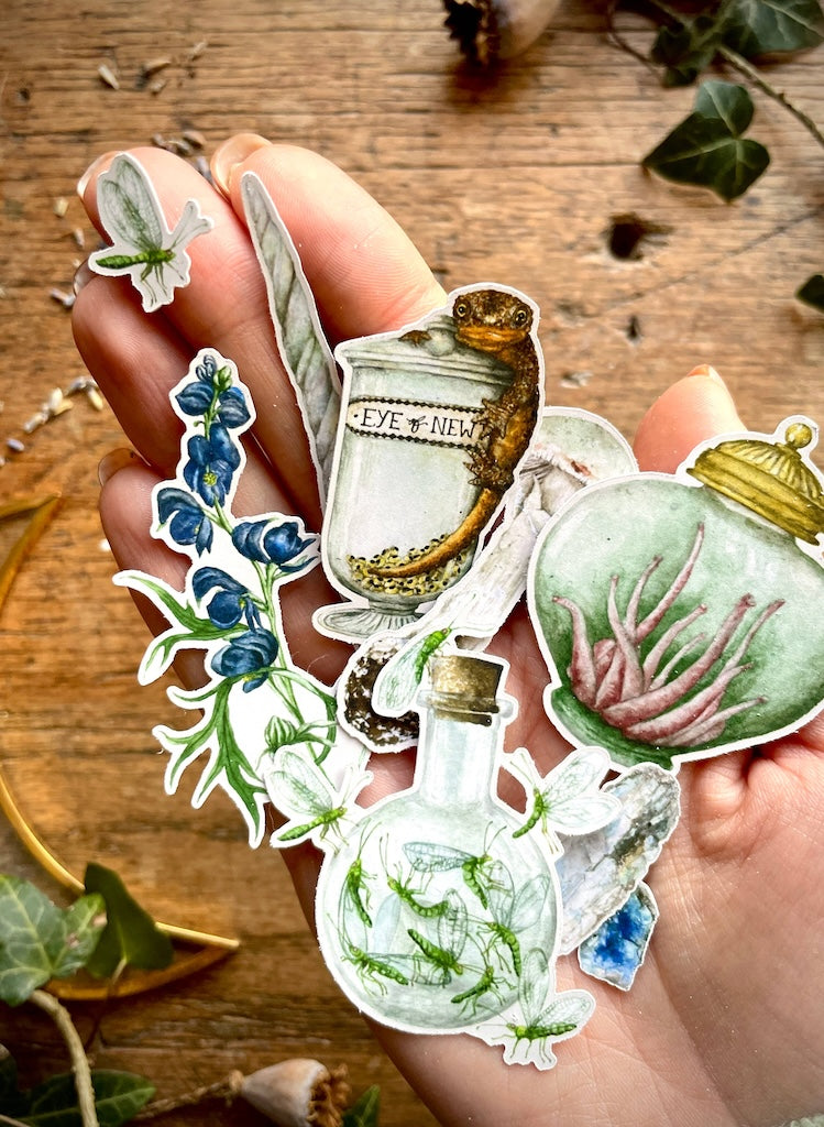 Potion making stickers held in a hand.