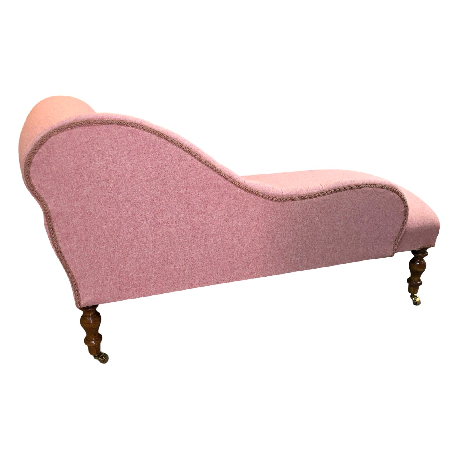 The back of a handcrafted chaise lounge in gorgeous powder pink wool mix fabric.