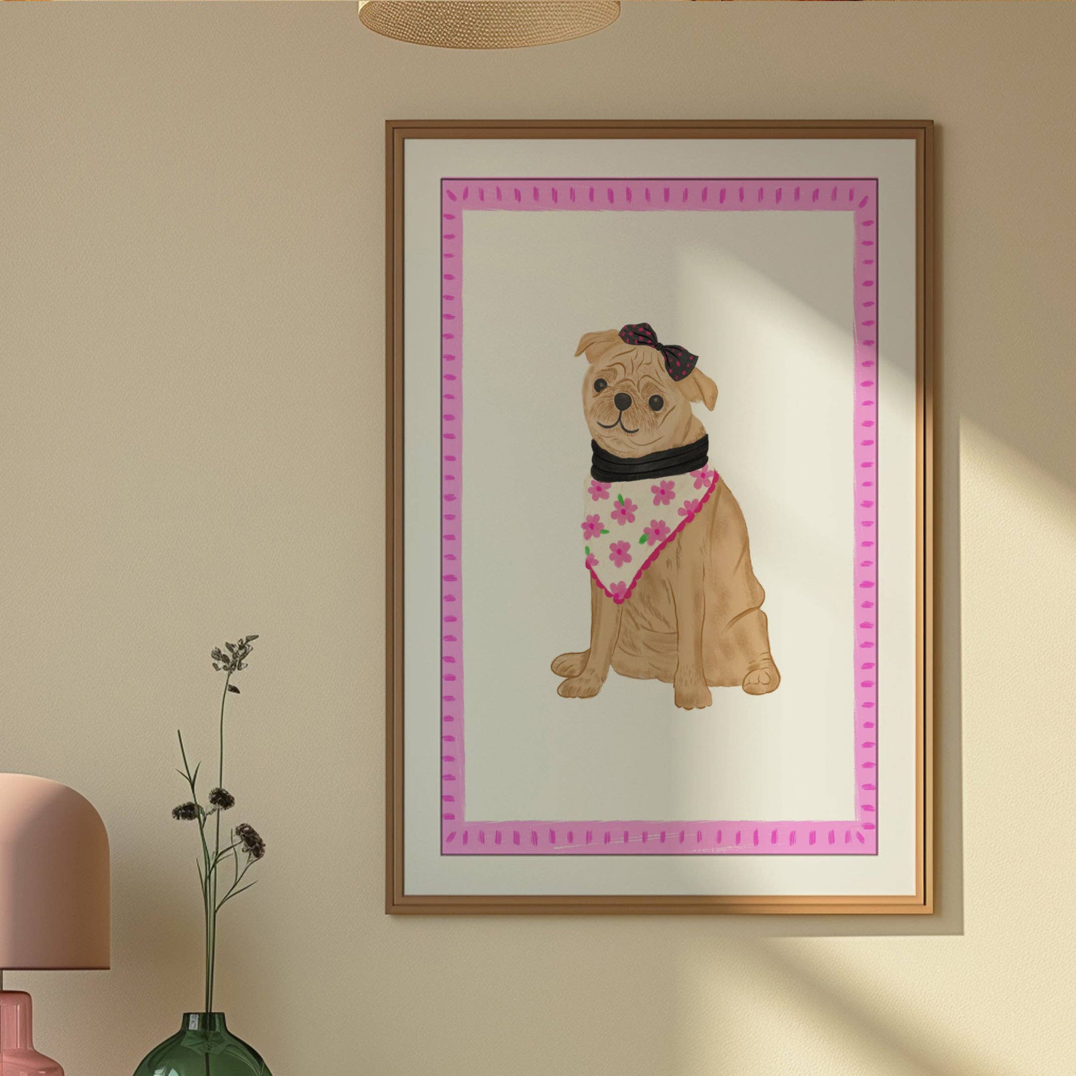 Illustration of a dog wearing a bandana in a pink frame, in a gold frame hanging on a wall.