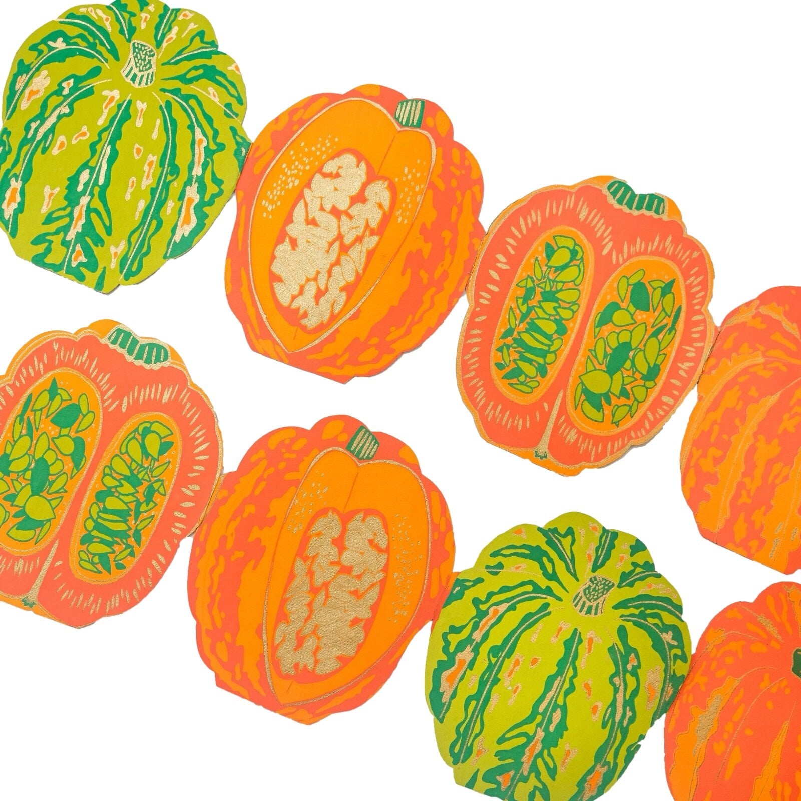 An orange and green pumpkin concertina garland on recycled paper.