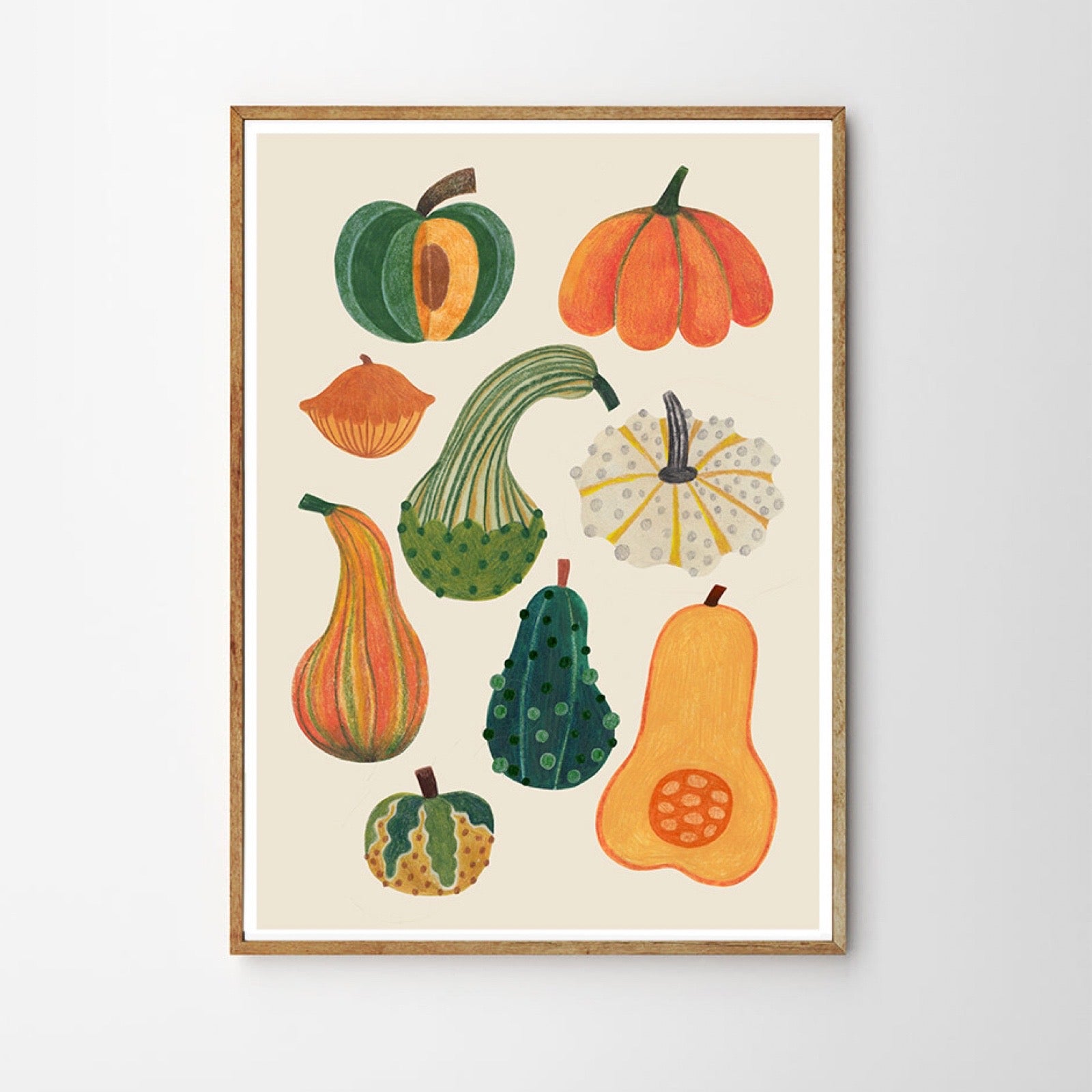 Framed artwork of various pumpkins on a beige background.