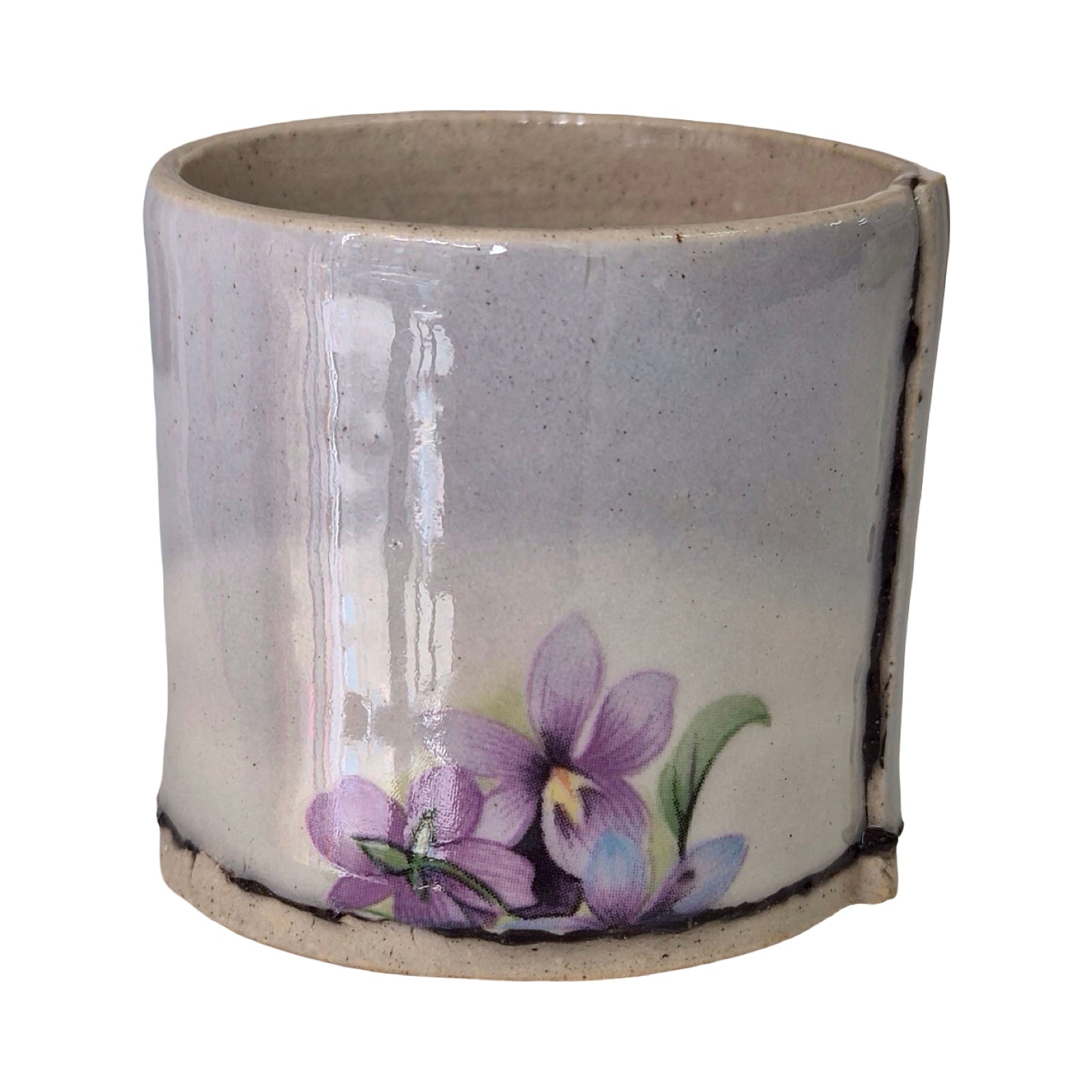 Ceramic planter with purple floral design on a white background.
