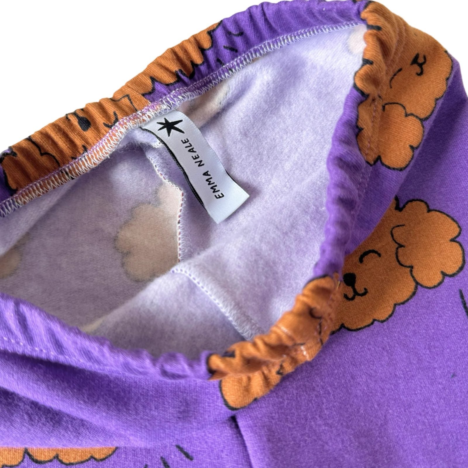 Purple baby joggers with a poodle pattern, featuring elastic waistband and cuffs.