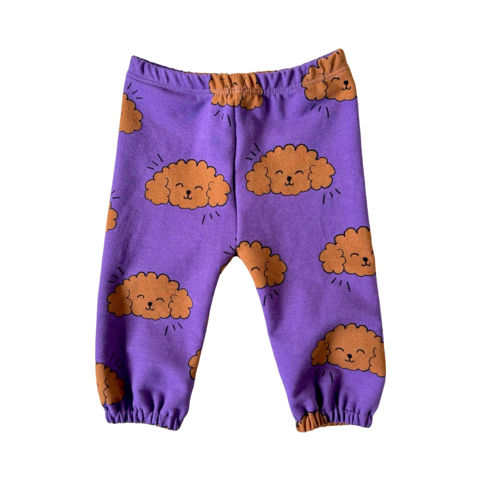 Purple baby joggers with a poodle pattern, featuring elastic waistband and cuffs.