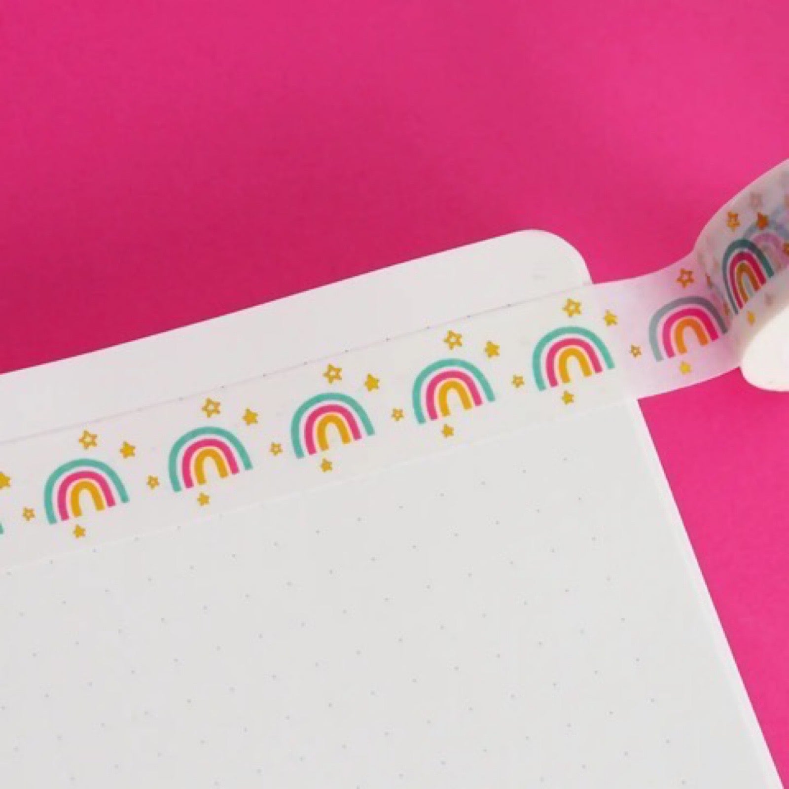 This colourful washi tape features a repeating rainbow with gold stars. Perfect for crafting and decorating letters.