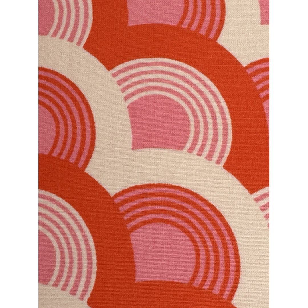 Close up of fabric in red, pink and white rainbows