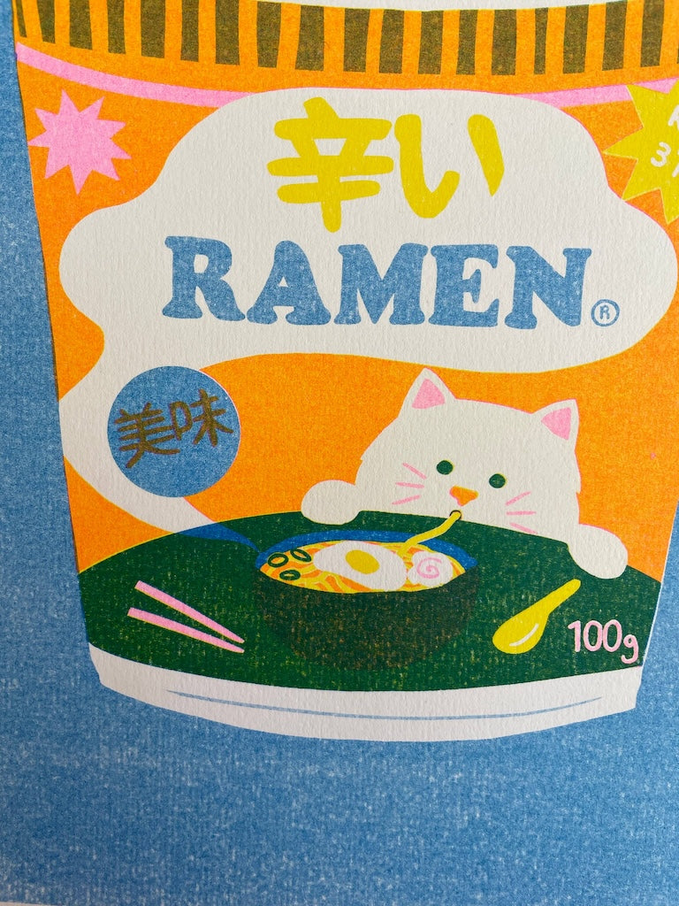 This colourful risograph print features a tub of ramen noodles against a blue background.