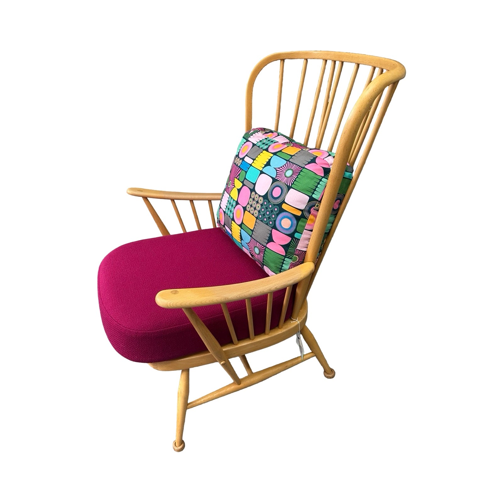 Wooden chair with a pink cushion and colorful patterned backrest on a white background