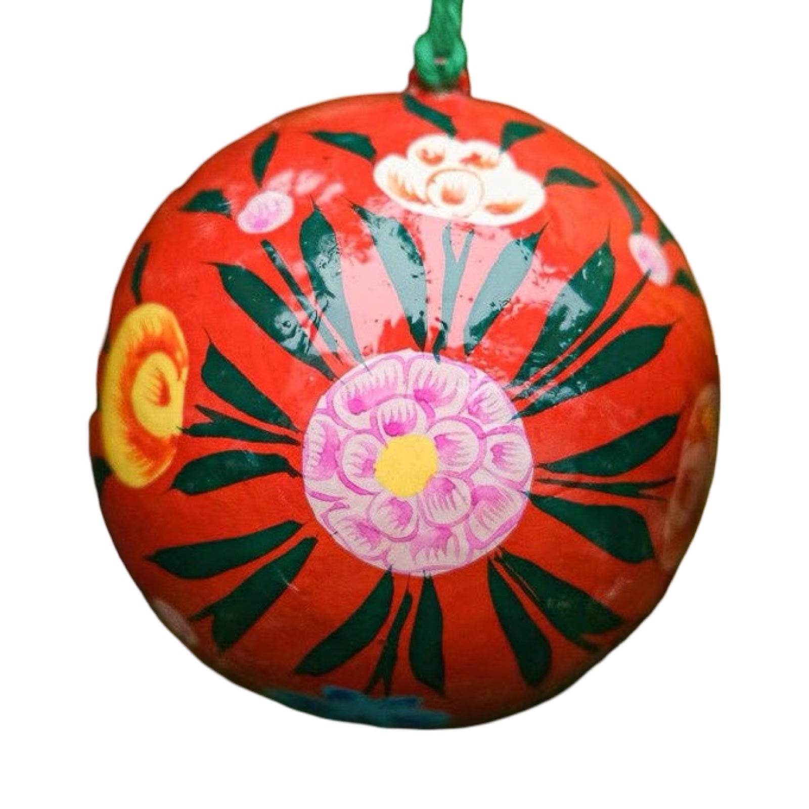 A round papier mache bauble in red with a pink, green, yellow and white floral design.