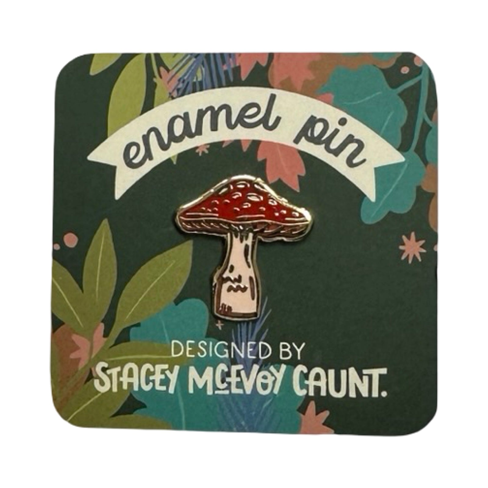 Enamel pin with mushroom design on a decorative backing.