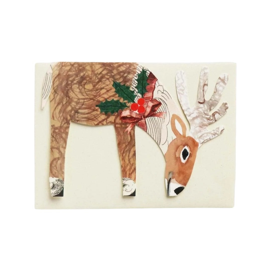 Reindeer-shaped card of a brown and white reindeer with holly and berries tied with ribbon around its neck, against an ivory coloured envelope