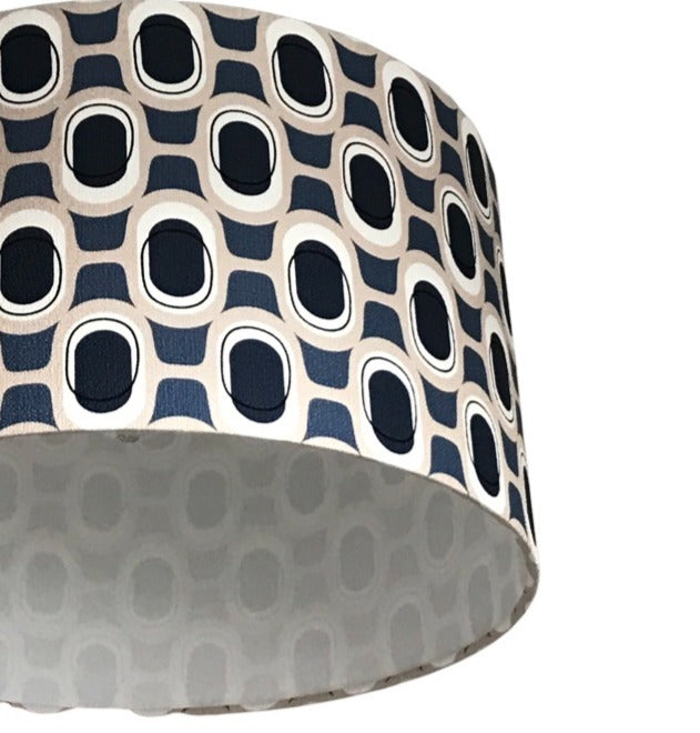 Drum lampshade covered in mid-century inspired barkcloth fabric in a navy and grey pattern