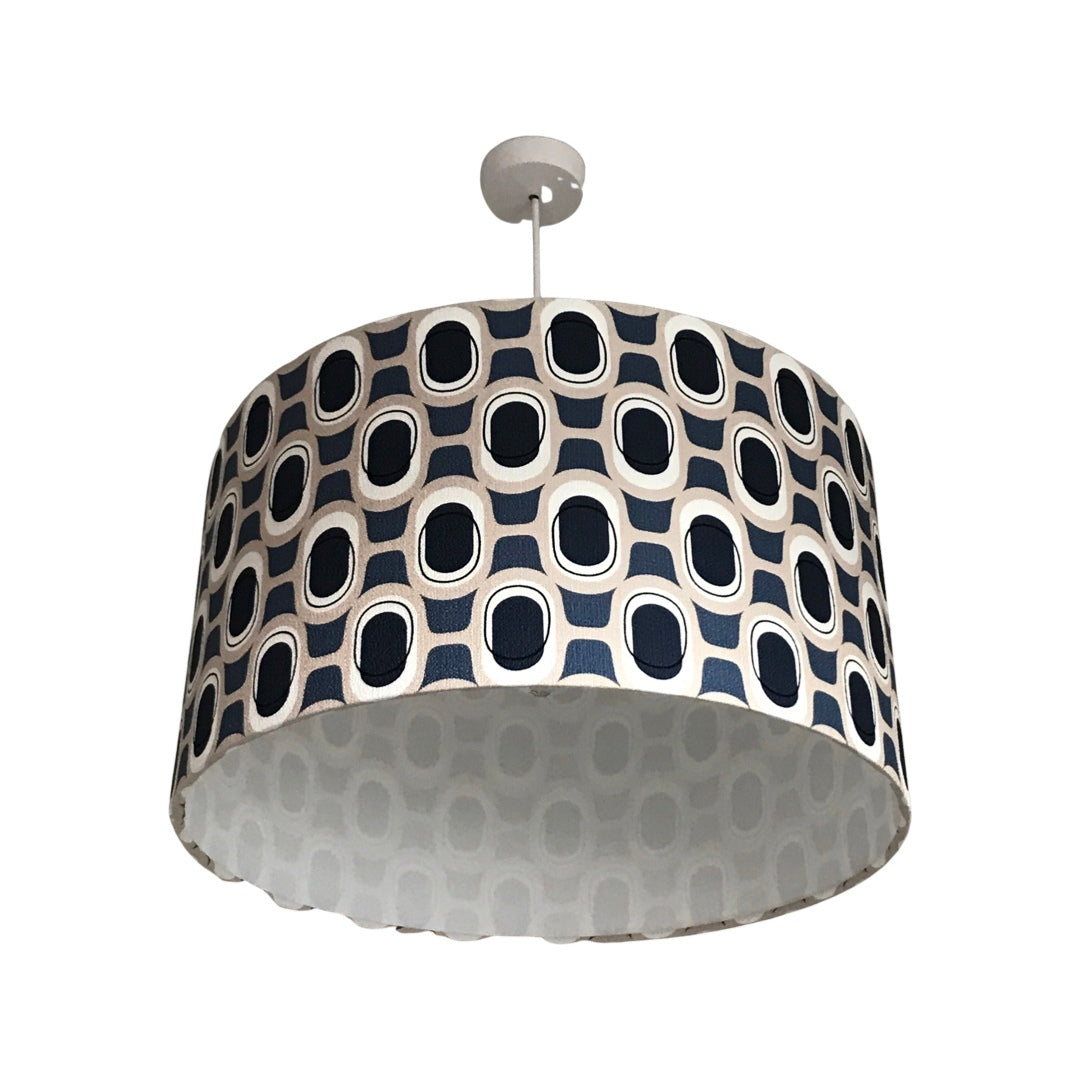 Drum lampshade covered in mid-century inspired barkcloth fabric in a navy and grey pattern