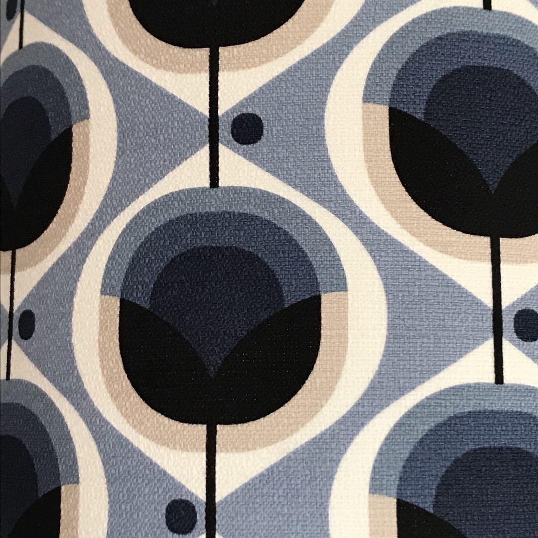A square cushion cover with a retro abstract floral design in blue and grey.