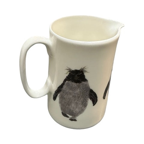 White fine-bone china milk jug featuring an illustration of a waddle of rockhopper penguins.