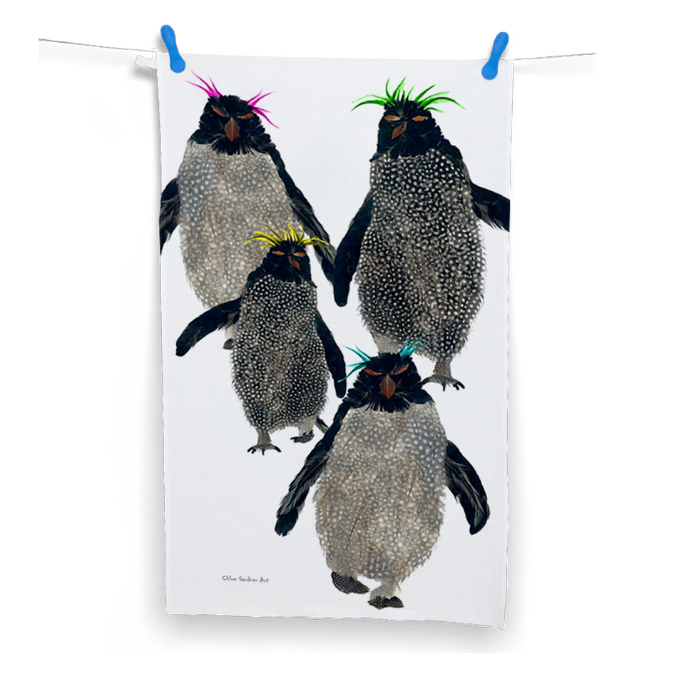This white tea towel features an illustration of 4 rockhopper penguins.