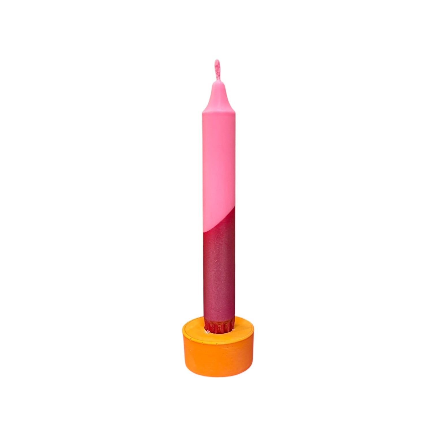Pink and red metallic candle with an orange base on a white background