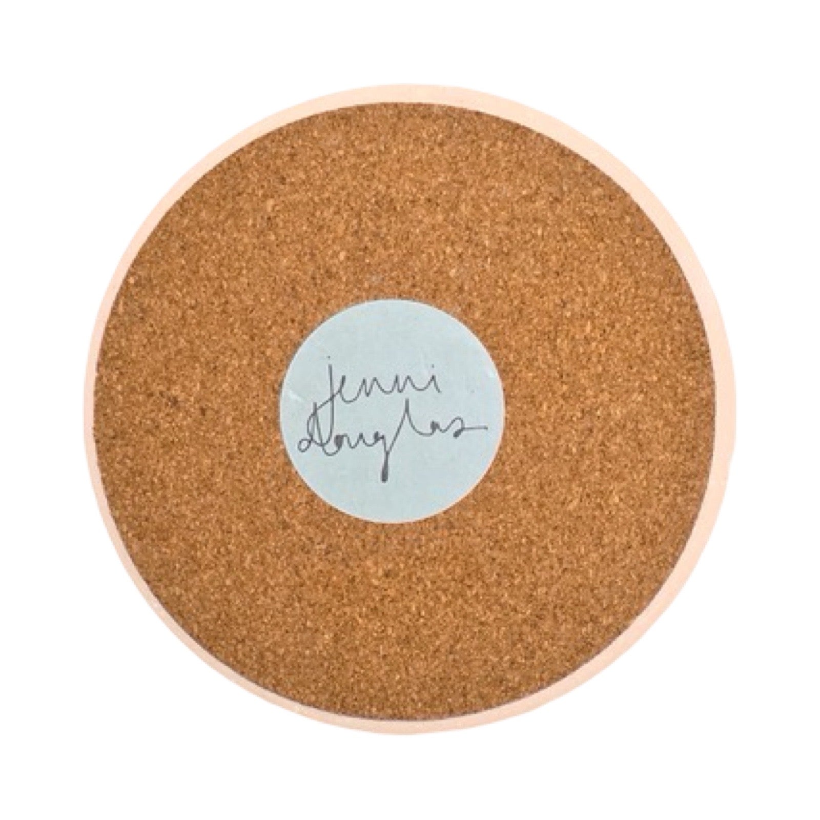 The cork back of a round ceramic coaster