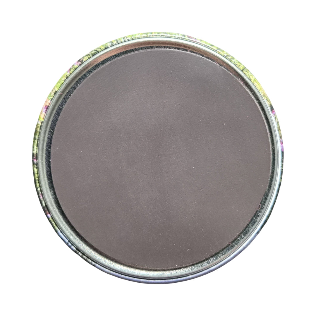 The back of a round magnet against a white background.