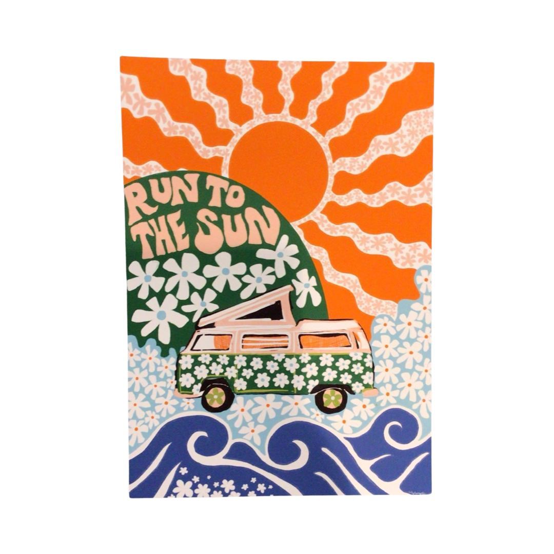 Art print featuring a green and pink campervan with white daisies in a blue field of daisies along the sea all under a huge orange sun.