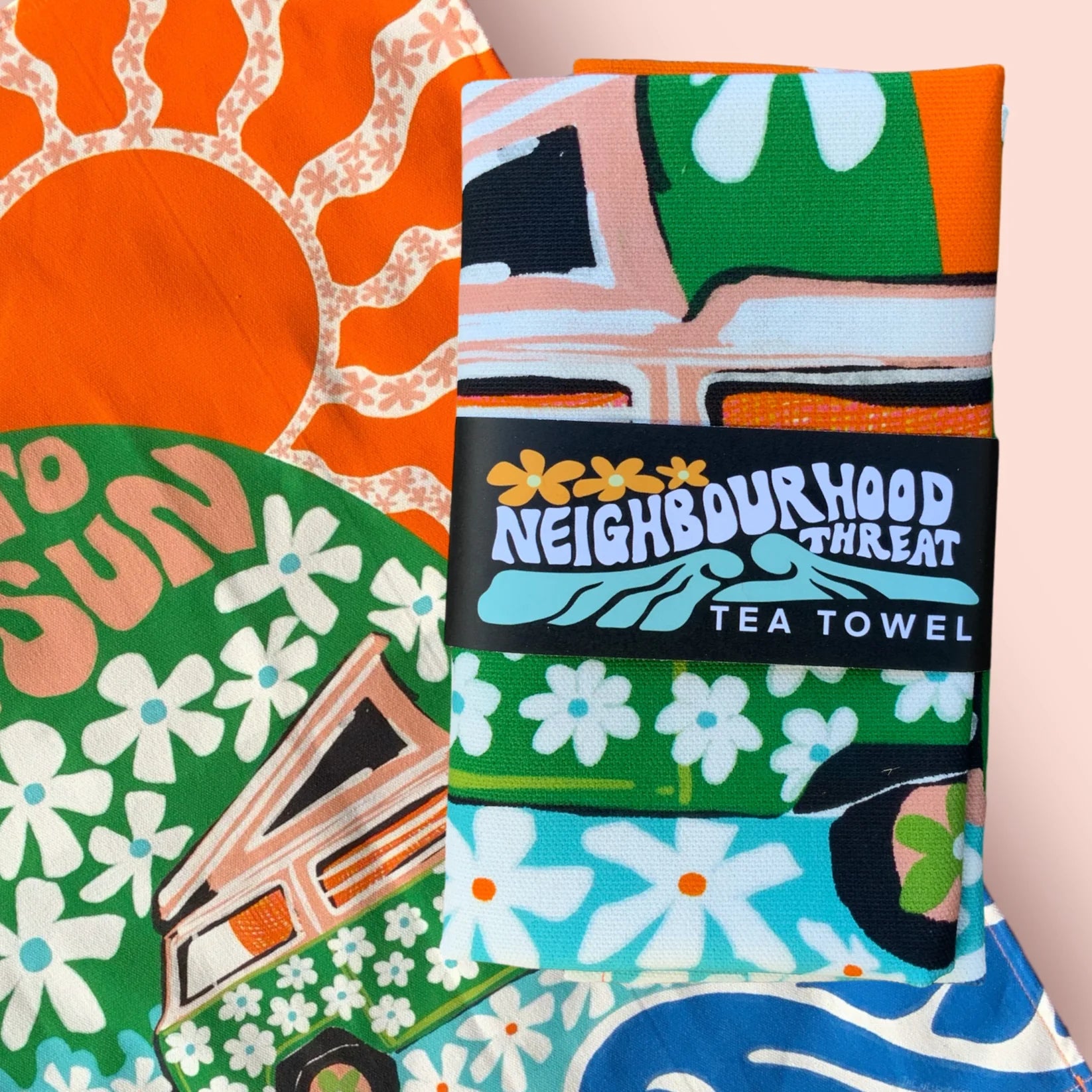 Colourful tea towel with abstract design and 'Neighbourhood Threat' branding.
