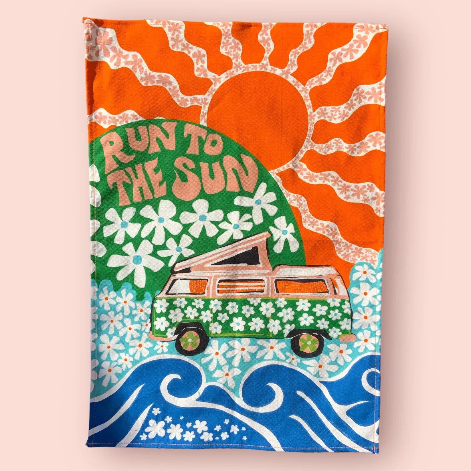 A statement tea towel featuring retro van with floral green design, surrounded by an orange sun and blue waves. The text 'Run To The Sun' sits in a green circle with white flowers.