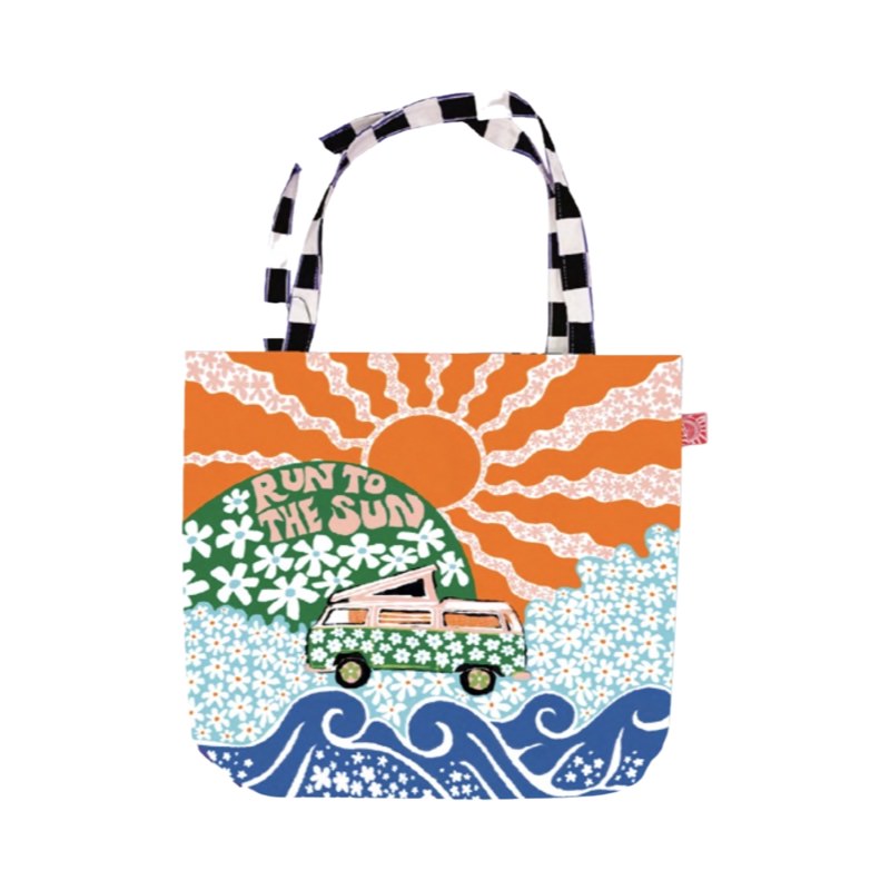 A fabulous, bright and colourful tote bag featuring a pink campervan covered in green daisies on a meadow of blue daisies, a large orange sun and blue waves.