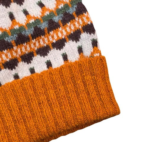 This orange, navy, blue and white striped woollen hat is handmade using only the softest Scottish spun lambswool.