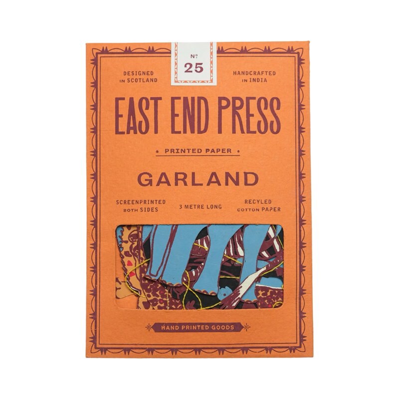 An orange paper packet holding a safari paper garland.