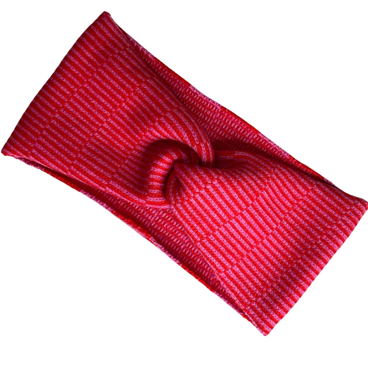 A red knit headband with thin white vertical stripes, with a knot in the centre against a plain white background.
