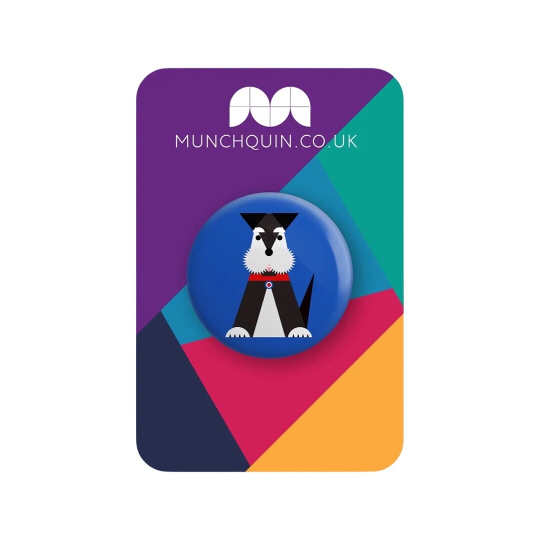 A round badge featuring a stylized illustration of a Schnauzer dog wearing sunglasses and a red and blue jacket on a blue background.