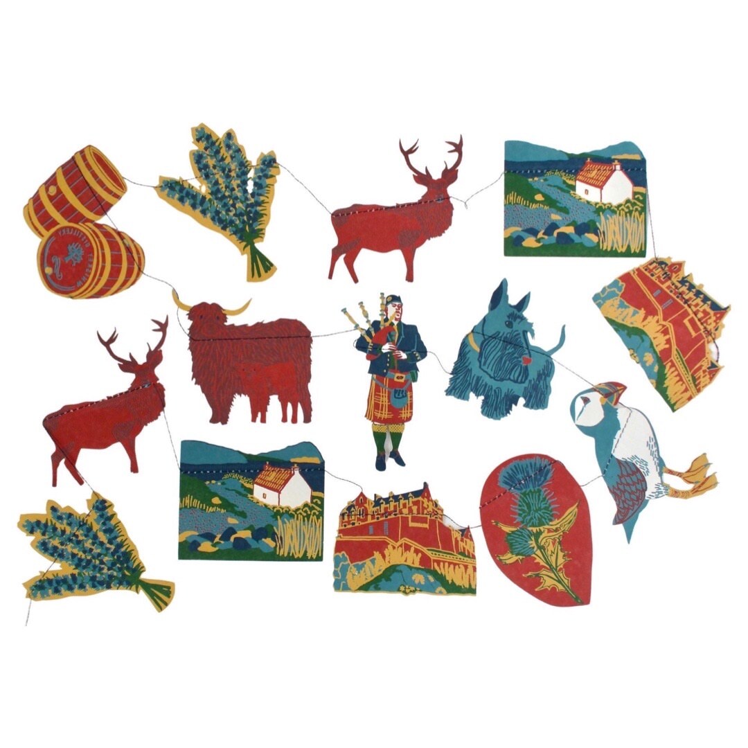 A Scotland paper garland featuring fourteen screen-printed paper Scottish-themed designs (pipers, scottie dogs, Edinburgh Castle, stags and thistles.