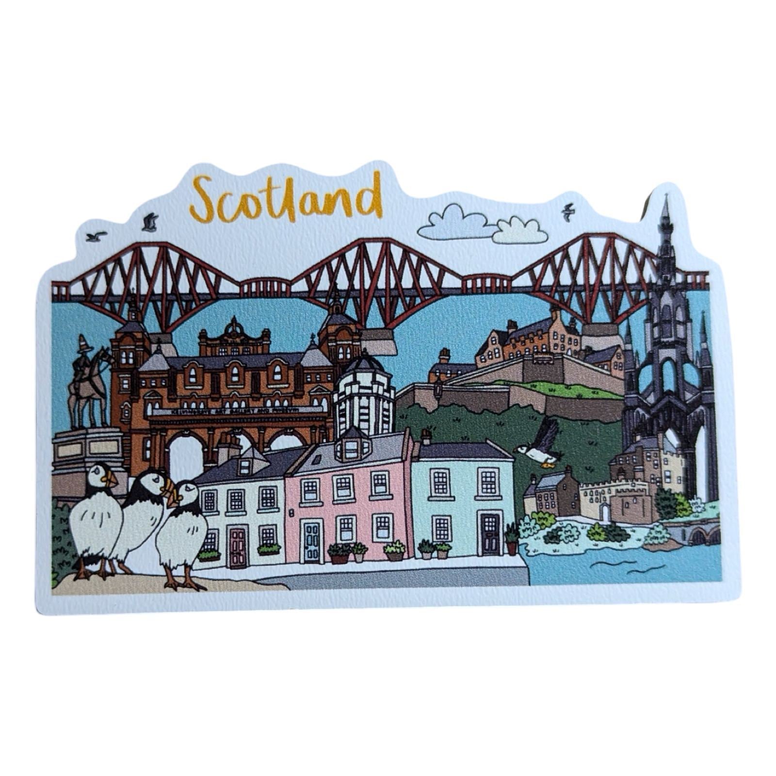 A wooden magnet with a printed illustration of Scottish landmarks and the word 'Scotland' written across the top.