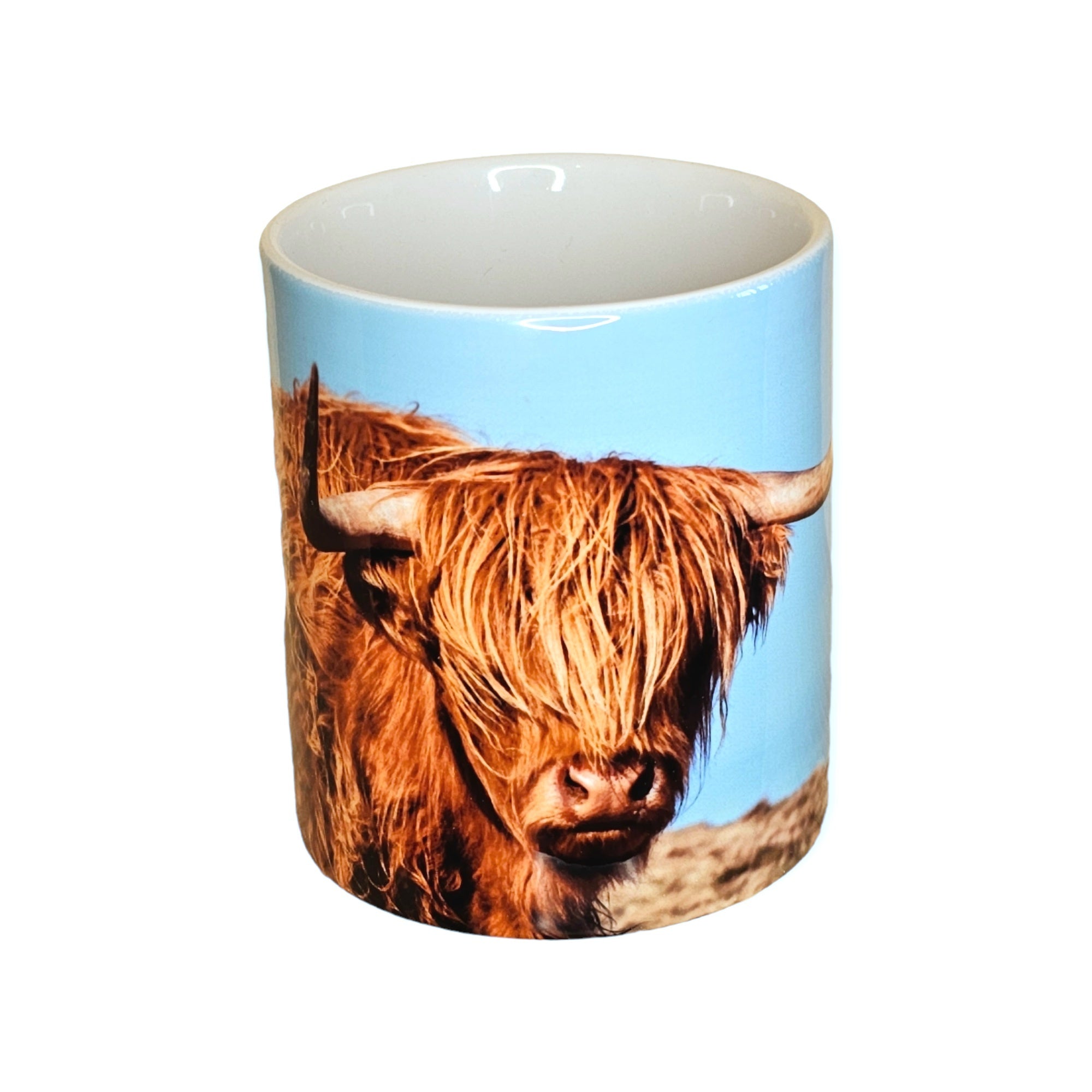 A mug featuring a Highland Cow.