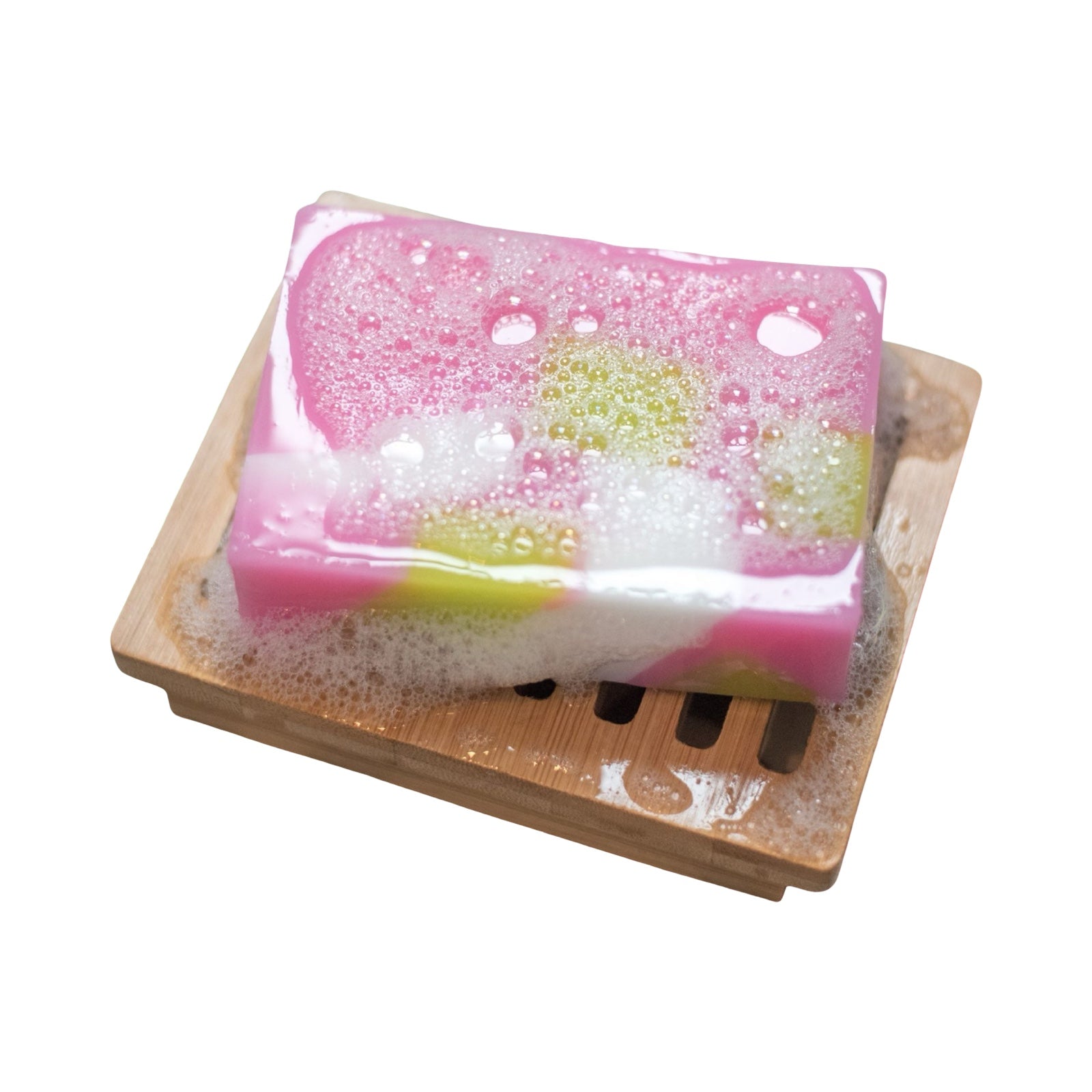 Pink Scottish rose handmade soap bar on a plank of wood.