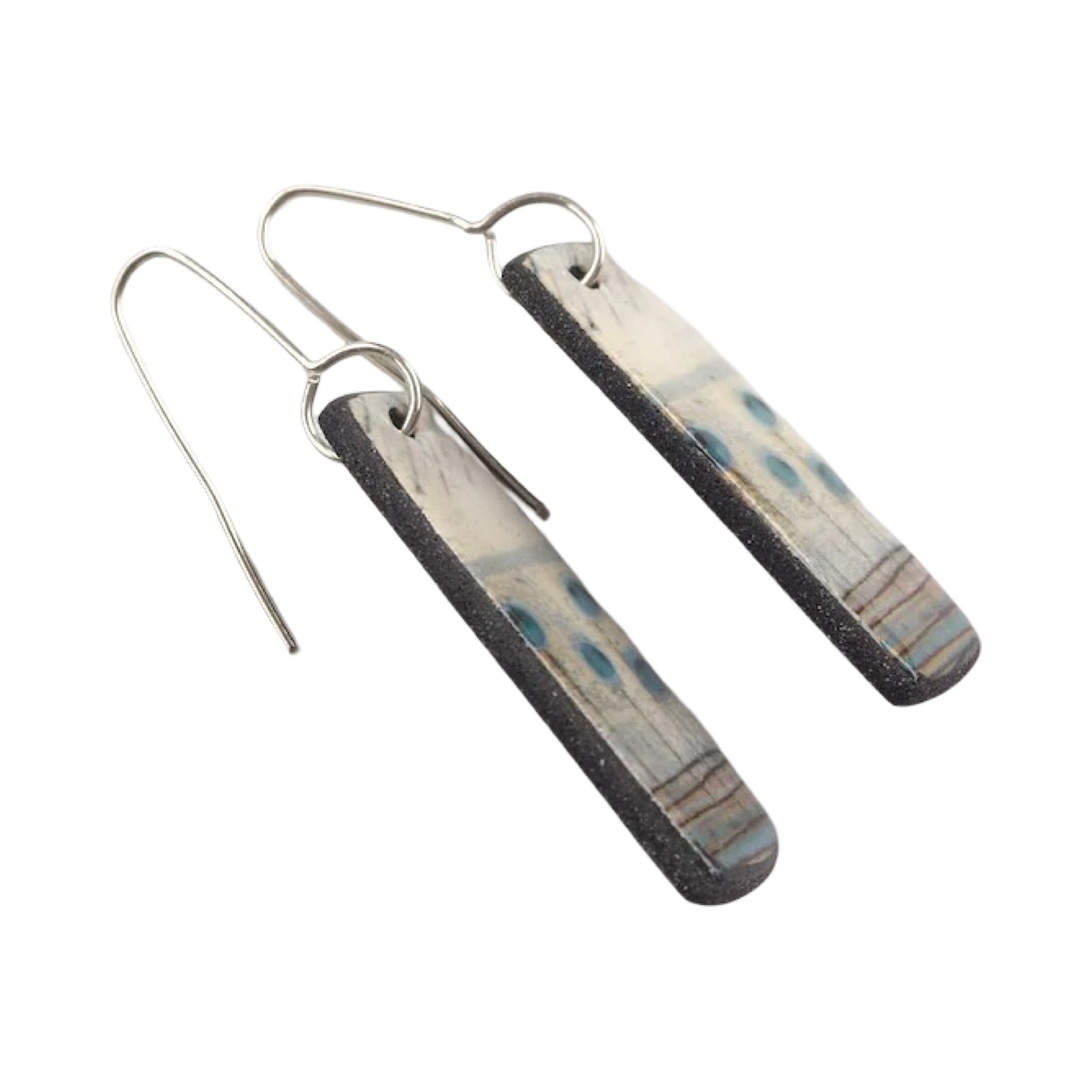 These porcelain drop earrings are made from black porcelain casting slip layered with a white decorating slip and a ceramic decal.