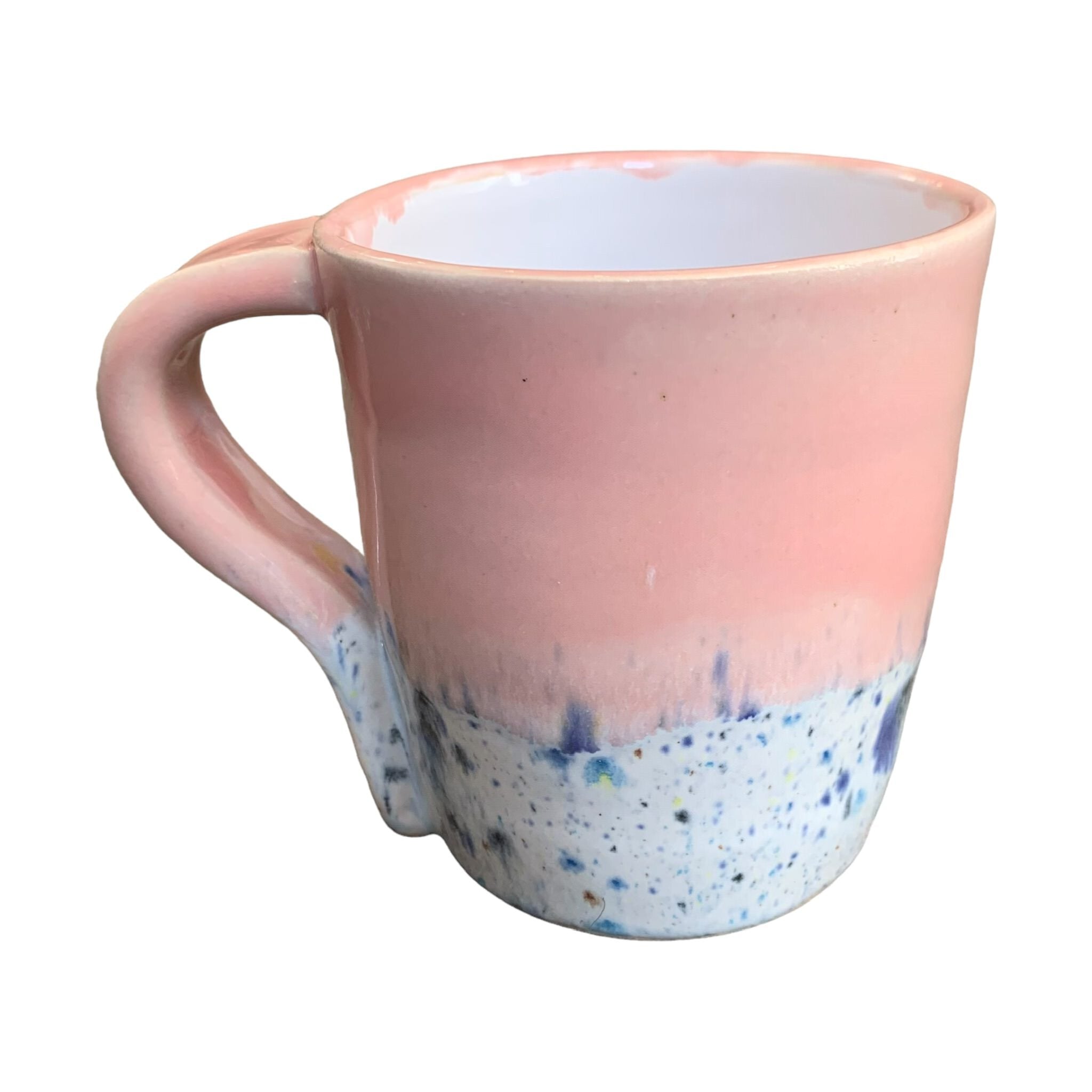 A pink mug with a shoreline pattern around the bottom half.