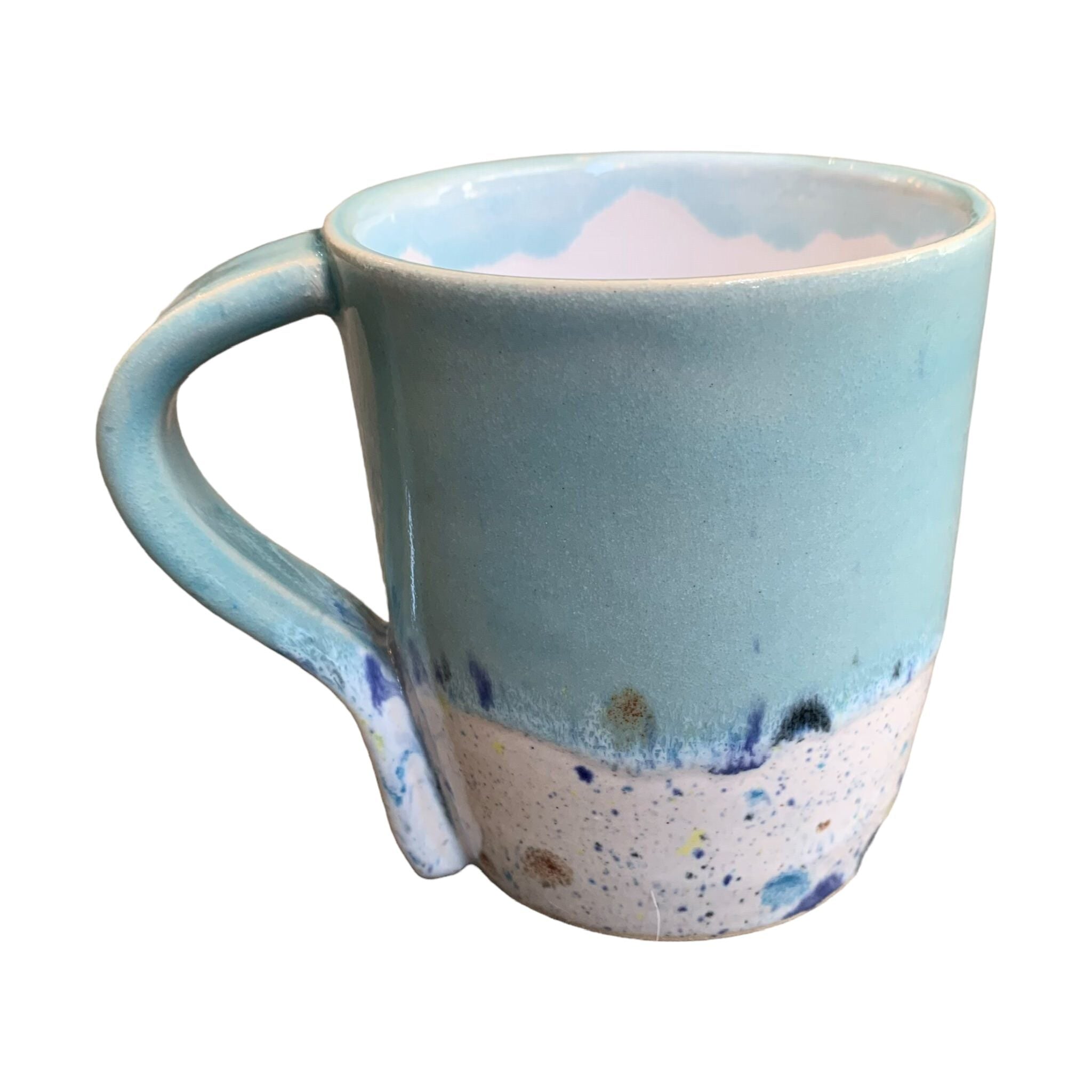 A turquoise mug with a shoreline pattern around the bottom half.