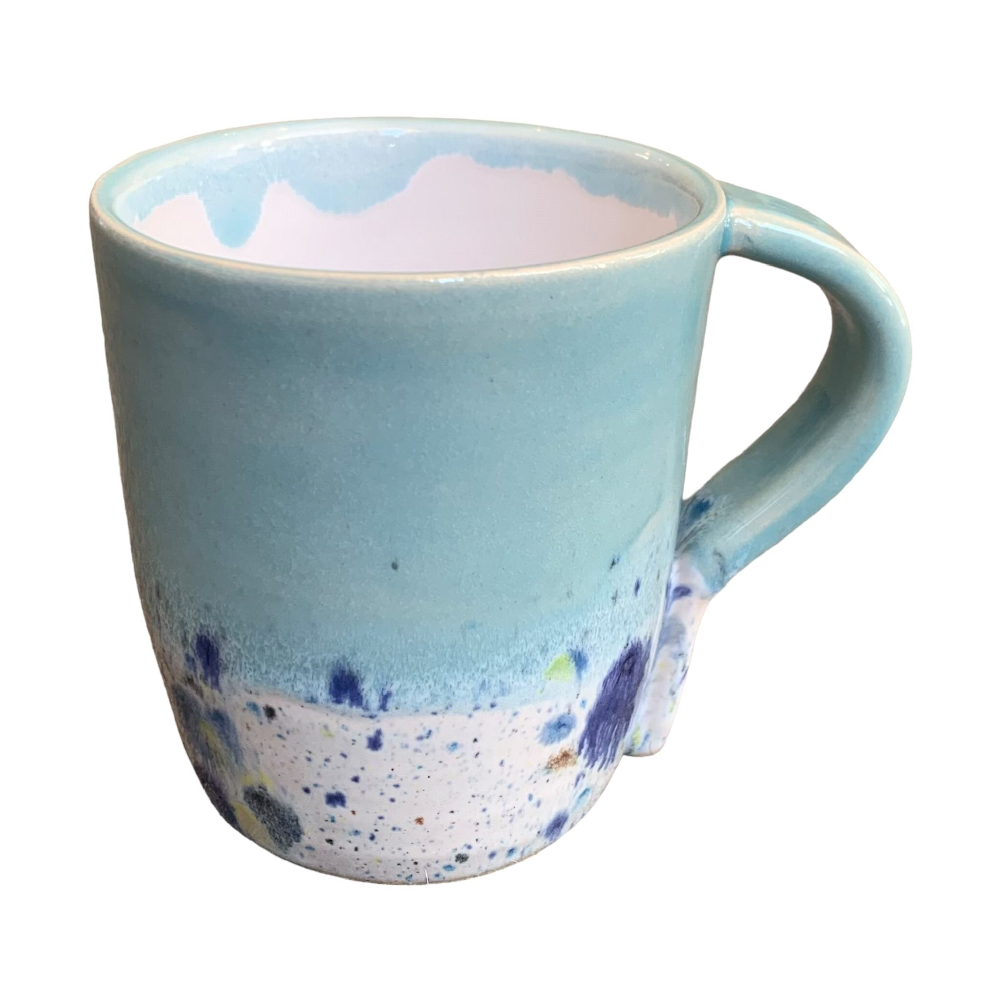 A turquoise mug with a shoreline pattern around the bottom half.