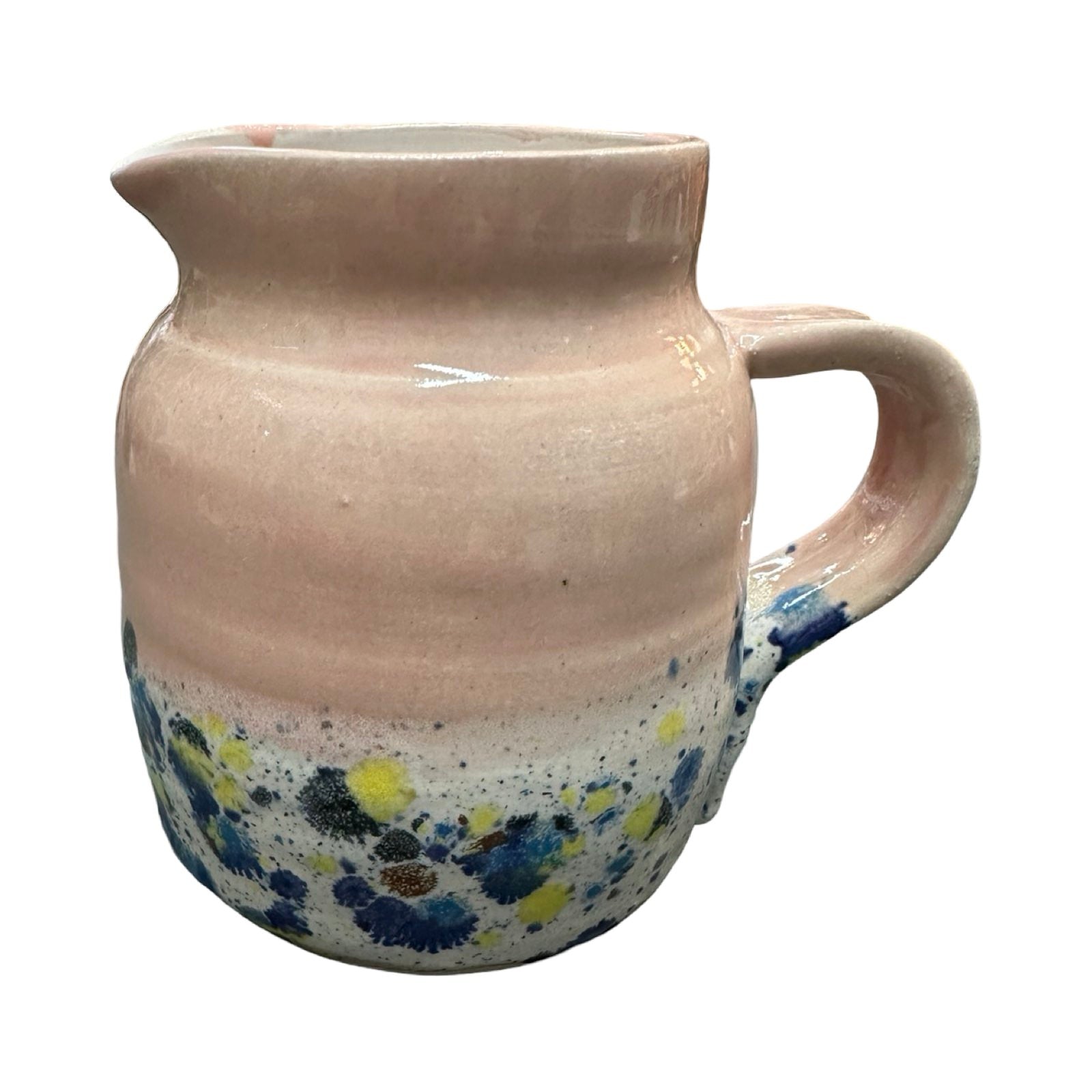 Handmade pottery jug in light pink and white with a colour splash design.