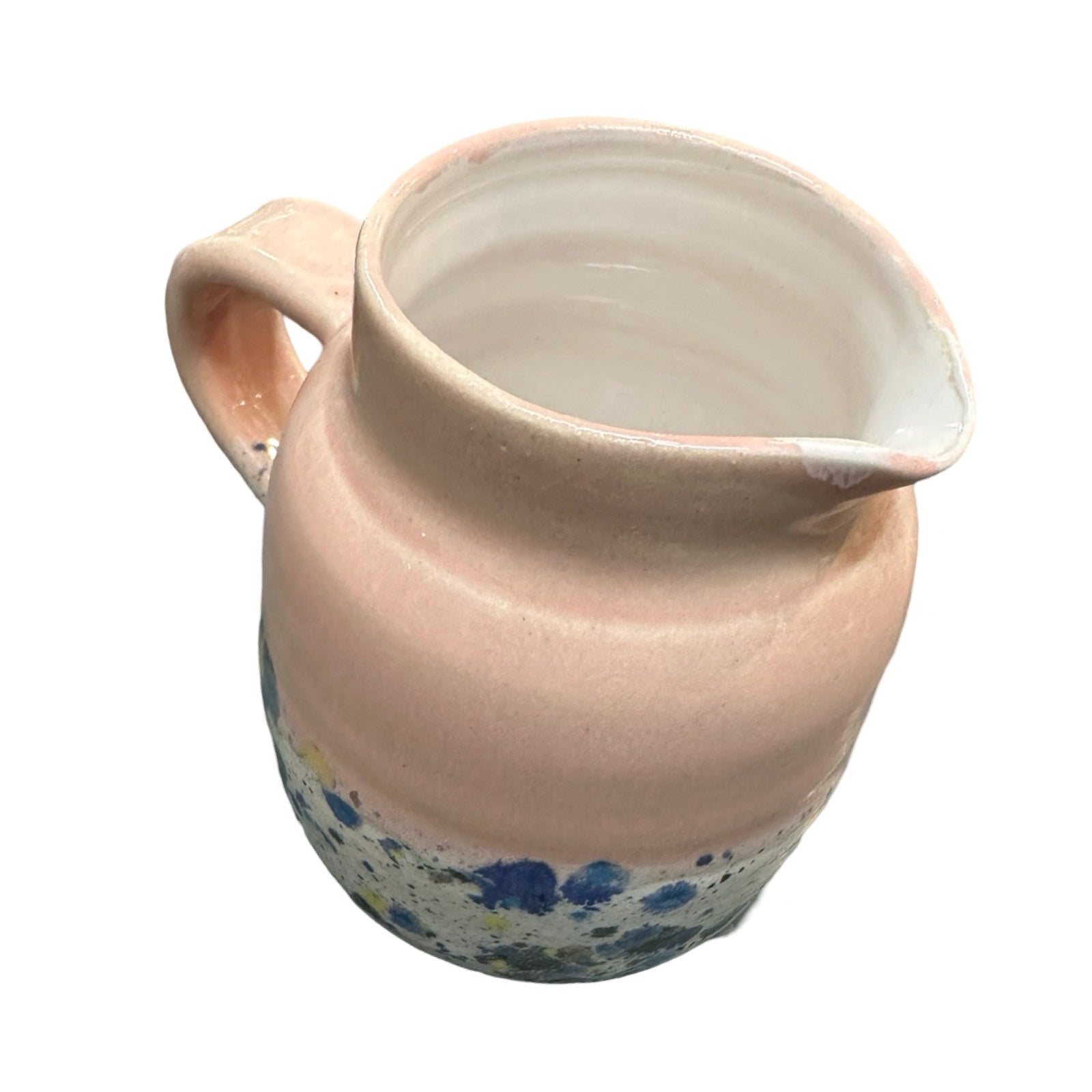 Handmade pottery jug in light pink and white with a colour splash design.
