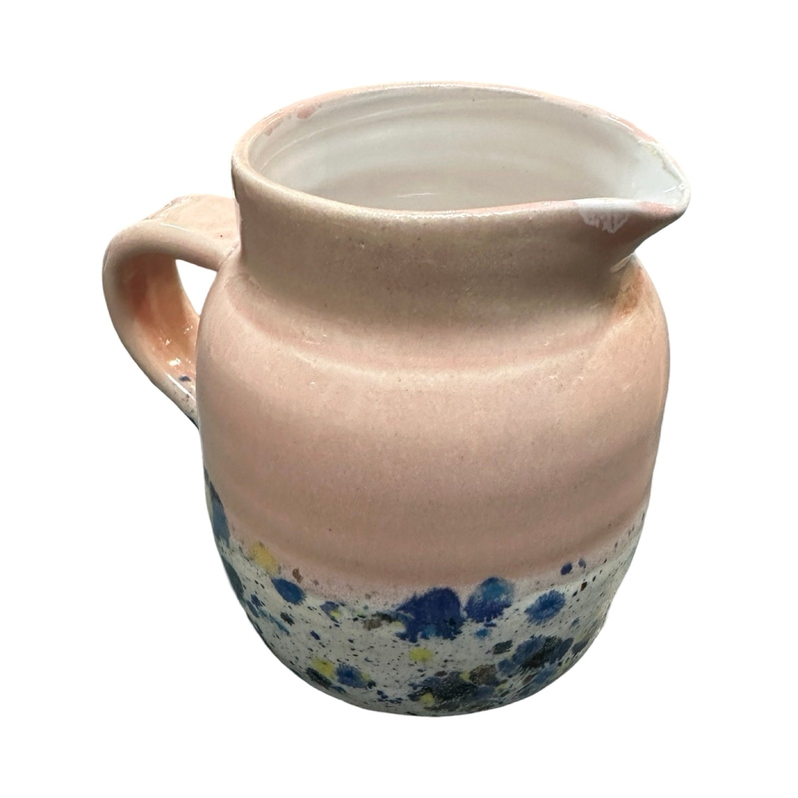 Handmade pottery jug in light pink and white with a colour splash design.