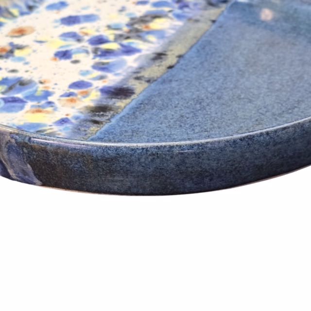 Handmade ceramic trays with half in a shoreline design and half block colour, in blue.