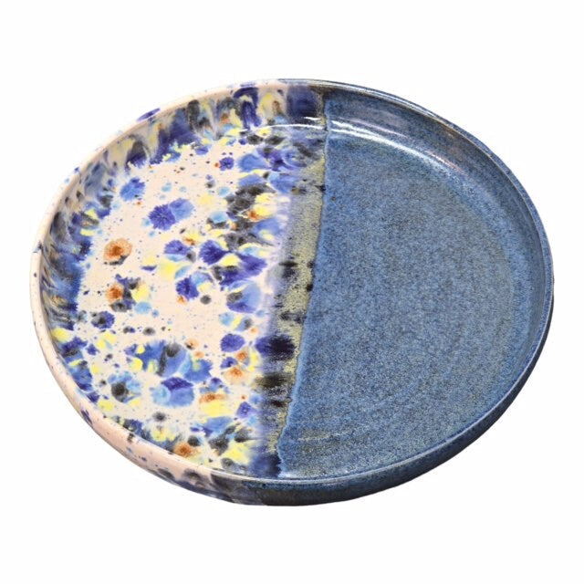 Handmade ceramic trays with half in a shoreline design and half block colour, in blue.