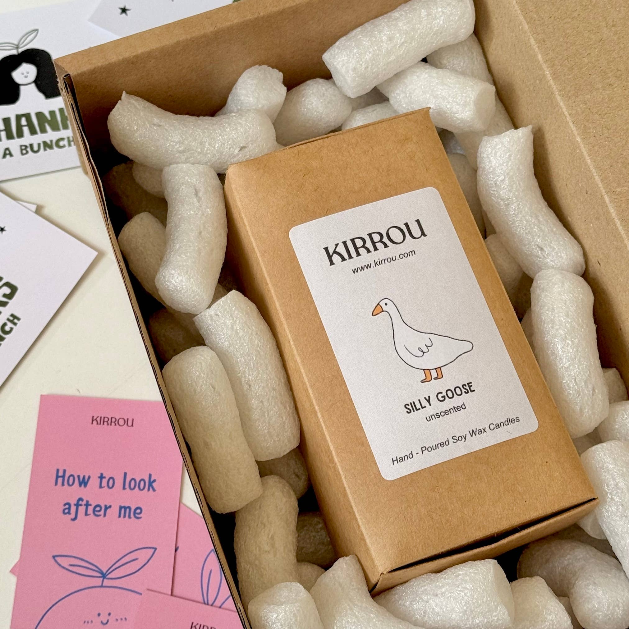 Kirrou candle packaging with branding and product details on a white surface.