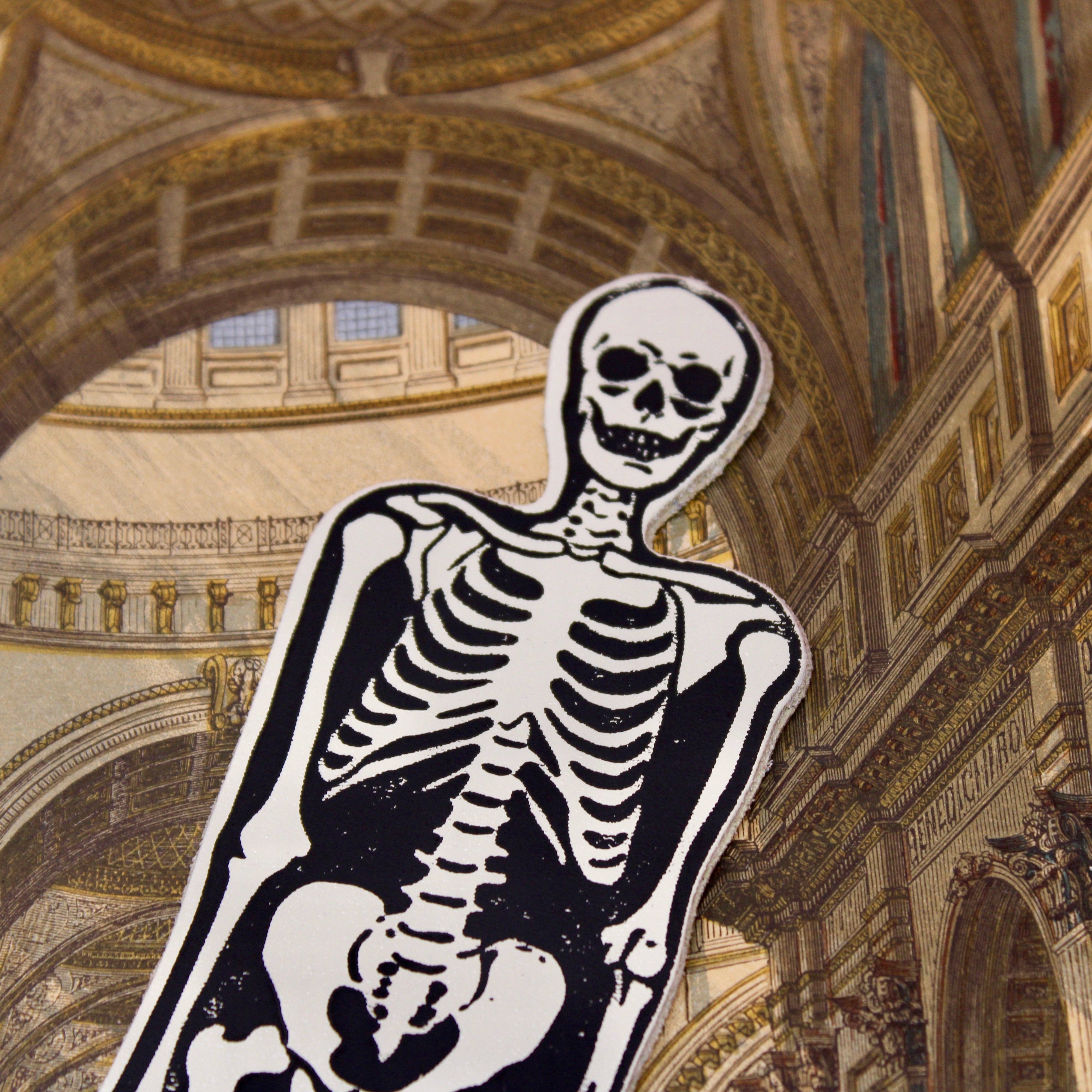 Skeleton bookmark in a grand architectural setting.